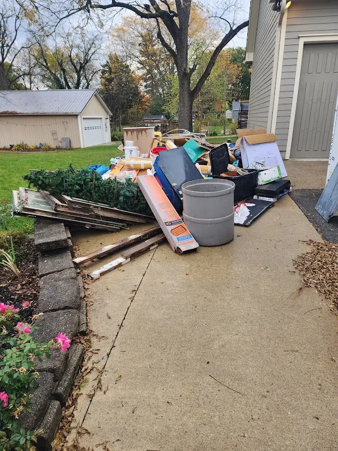 Dumpster being loaded with debris for 12 Yard Dumpster Rental in Lafayette